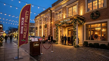 Upscale restaurant storefront with Book Your Holiday Party Private Dining Room feather flag fluttering outdoors