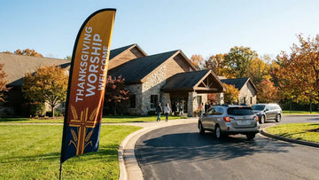 Thanksgiving church feather flags welcoming families at a church campus entrance