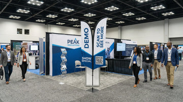 Trade show booth using an XS 6ft double sided feather flag for two-way aisle visibility