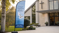 Grief Support feather flag at a modern church entrance