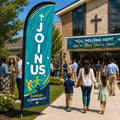 Join Us community church feather flag displayed near a busy fellowship courtyard with church members