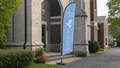 Grief Support feather flag at a traditional church side entrance