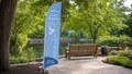 Grief Support feather flag at a quiet outdoor gathering area