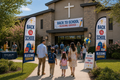 Two Back To School Blessing church feather flags flanking main entrance of church with families arriving