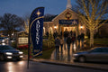 Church feather flag Christmas Advent placed roadside 500ft before entrance visible to Sunday traffic