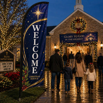 Navy and gold Christmas church feather flag with WELCOME text outside a decorated Advent church service