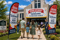 Two Grand Opening / New Church Plant church feather flags flanking main entrance with greeters and families arriving