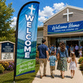 Soft silver memorial service church feather flag with WELCOME and YOU ARE WELCOME HERE text outside a peaceful church