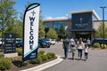 Modern Multi-Campus church feather flag at parking lot entrance guiding first-time visitors