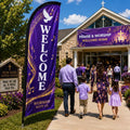 Praise and worship church feather flag with purple and gold design outside a contemporary church entrance