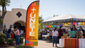 Hispanic ministry feather flag at festive outdoor church celebration