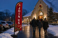 Christmas Join Us church feather flag guiding families from parking lot to service entrance