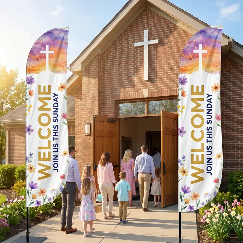 Two church Welcome feather flags flanking the main entrance of a brick church — families in Sunday attire walking between the flags