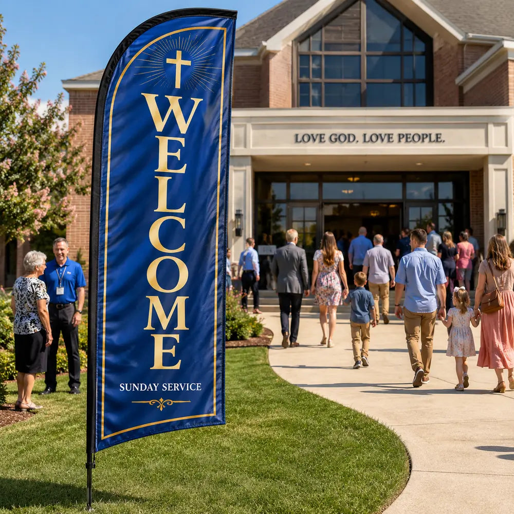 Classic blue and gold church feather flag with welcome message outside a busy Sunday church entrance