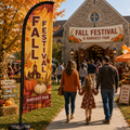 Fall Festival Harvest Fair church feather flag on church lawn with pumpkins, families, and autumn event booths