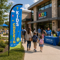 Kids ministry check-in feather flag outside church entrance