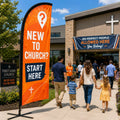 Orange New To Church guest services feather flag outside a church welcome table and entrance