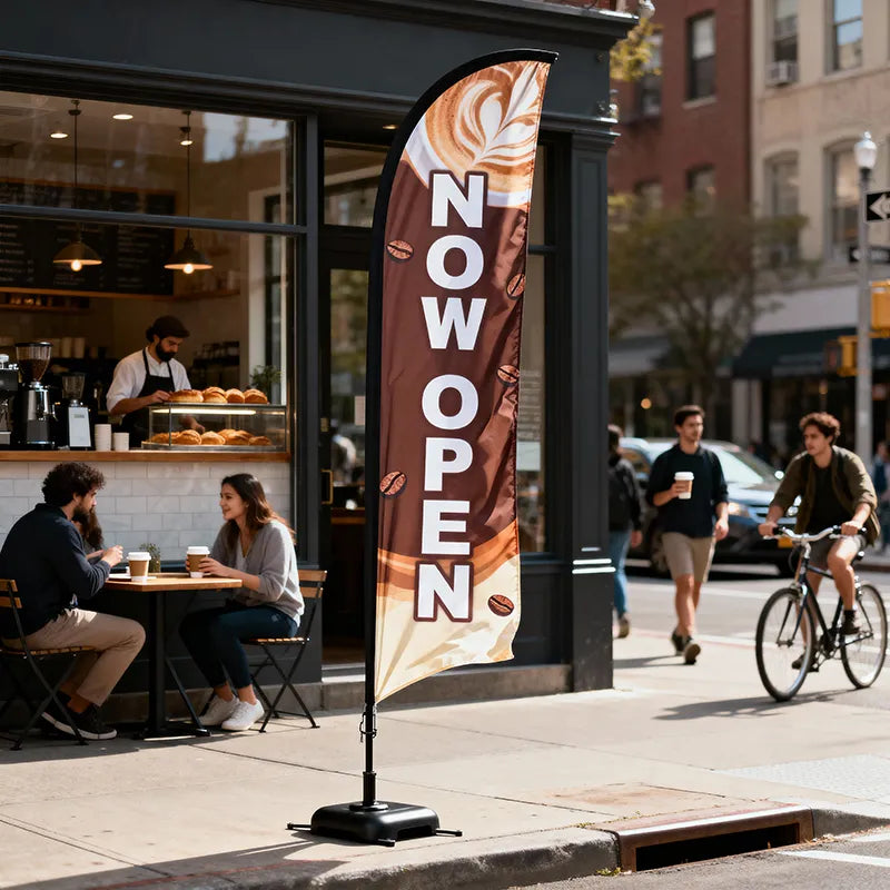 NOW OPEN feather flag in front of a busy coffee shop with customers and barista inside