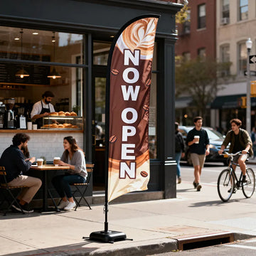 NOW OPEN feather flag in front of a busy coffee shop with customers and barista inside