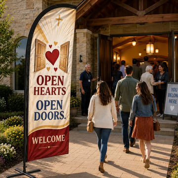 Open Hearts Open Doors church feather flag displayed beside open church doors with guests arriving