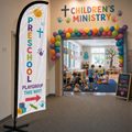 Preschool and playgroup directional church feather flag at children’s ministry wing entrance