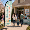 Safe nursery and toddler check-in church feather flag outside a family ministry entrance with parents and volunteers