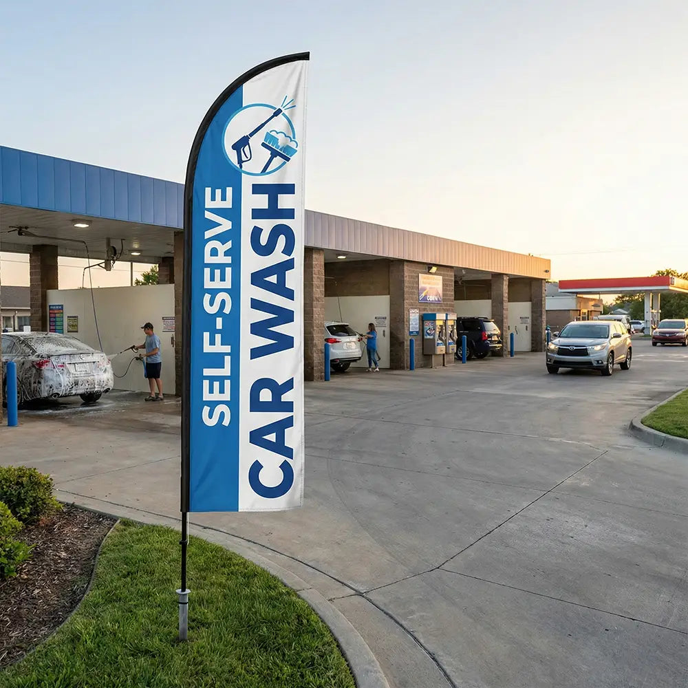 Instructional Self-Serve Car Wash feather flag guiding drivers toward DIY wash bays during sunset.