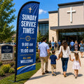 Sunday Service Times church feather flag with 9 AM and 11 AM schedule near a busy church parking walkway