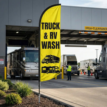 High-visibility yellow and black Truck & RV Wash feather flag positioned at a high-clearance wash bay.