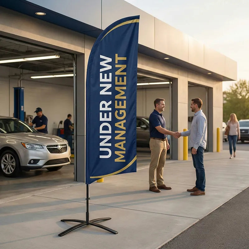 Professional navy and gold Under New Management feather flag signaling a fresh start and improved quality at a car wash location.
