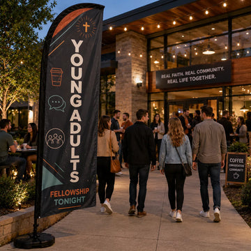 Young Adults Fellowship church feather flag outside a church courtyard café with young adults gathering at night